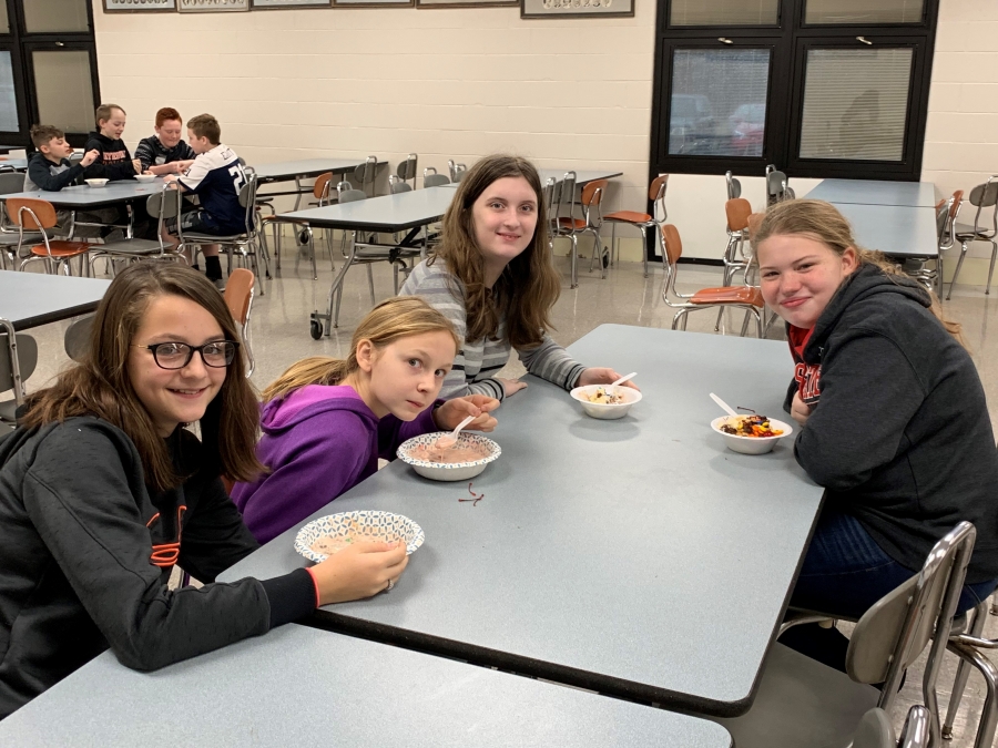 students at tables with bowls of ice cream